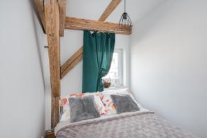 ein Schlafzimmer mit einem Bett mit einem grünen Vorhang in der Unterkunft Apartament Mikołowska in Gliwice