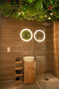 a bathroom with a sink and two lights at Vivez une experience unique a Carcassonne in Carcassonne