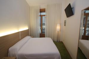 Posteľ alebo postele v izbe v ubytovaní Hotel Cal Piteu