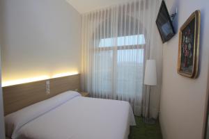 Posteľ alebo postele v izbe v ubytovaní Hotel Cal Piteu