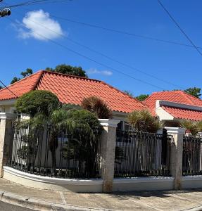 a black fence in front of a house at Villa Caterina in Dajabón