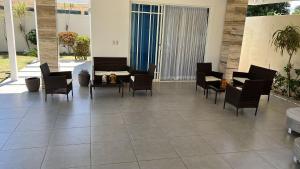 a patio with chairs and a table and a couch at Villa Caterina in Dajabón