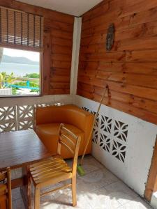 a room with a table and a chair and a couch at Meryem in La Trinité