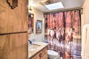 a bathroom with a shower curtain with horses on it at Tucson Home - Hiking Trail Access On-Site! in Avra