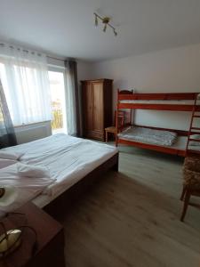a bedroom with a bed and a bunk bed at Villa Marcela in Karpacz