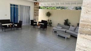 a patio with a couch and chairs and a table at Villa Caterina in Dajabón