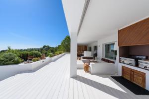 an open living room and kitchen of a house at Exquisite Ibiza Home Jaw Dropping Sea Views Casa Blanca Jondal 4 Bedrooms Gym Outdoor Kitchen San Jose in Sant Josep de sa Talaia