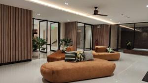 a lobby with couches and chairs in a building at Hi Chiangmai Hotel in Chiang Mai +49 photos
