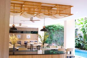 a dining room with tables and chairs and a pool at Hi Chiangmai Hotel in Chiang Mai