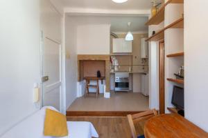 a living room with a table and a kitchen at Loft Mouraria in Lisbon