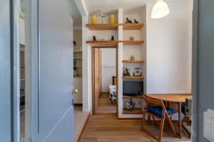 a kitchen and dining room with a table and chairs at Loft Mouraria in Lisbon