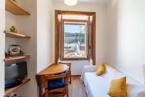 a living room with a couch and a window at Loft Mouraria in Lisbon