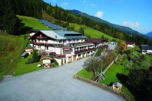 an aerial view of a large building on a hill at Jugend- und Familienhotel Venedigerhof in Neukirchen am Großvenediger