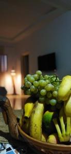 a basket of fruits and vegetables on a table at l' Escapade El Haouaria in Douar Hasni Salah +27 photos
