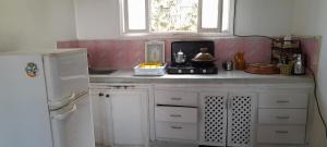 a kitchen with a stove and a microwave at Riad beach house in Mirleft