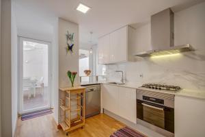 a kitchen with white cabinets and a stove top oven at Beds & Breaks Torrealba in Valencia