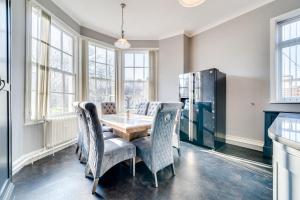 a dining room with a table and chairs at Wakefield Town House in Wakefield