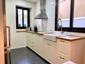 a kitchen with white cabinets and a sink and a window at Casa en Palafrugell - Costa Brava in Palafrugell