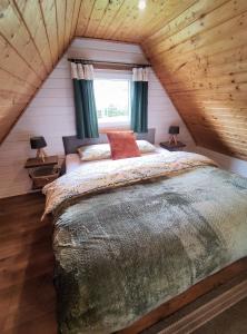 a bedroom with a large bed in a attic at Domek BB in Podgórzyn