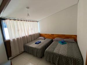 Ein Bett oder Betten in einem Zimmer der Unterkunft Pousada Ilha Sul