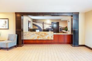 a hotel lobby with a reception desk and a chair at Staybridge Suites Denver - Central Park, an IHG Hotel in Denver