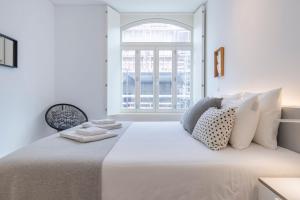 リスボンにあるModern Rustic Flat in Santos by LovelyStayの白いベッドルーム(大型ベッド1台、窓付)