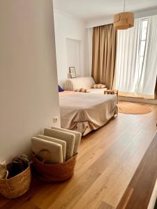 a bedroom with a bed and a chair on a wooden floor at ADI BOUTIQUE HOUSE in Thessaloniki