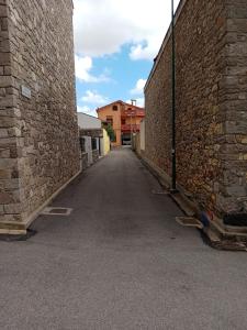 an empty alley between two brick buildings at Fontana Nuova in Sardara