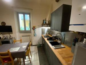 a kitchen with a counter top and a table with a tableablish at Double Accomodation In San Frediano in Florence