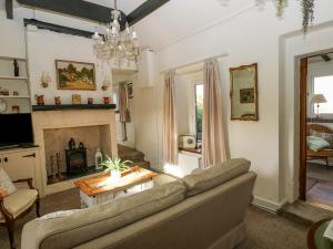 a living room with a couch and a fireplace at Prospect Cottage in Sowerby Bridge