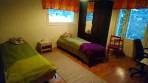 a bedroom with two beds and a window at Villa Vuopajanranta in Rovaniemi