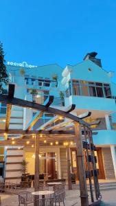 a building with tables and chairs in front of it at Social House in Addis Ababa