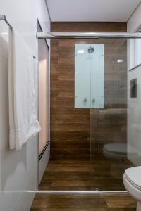 a bathroom with a glass shower and a toilet at Sfera Motel in Manaus +13 photos