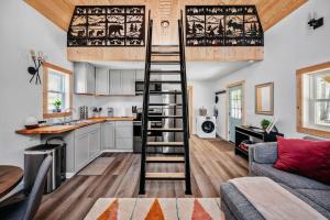 a loft conversions kitchen and living room with a ladder at Hygge Up North Bungalow in Bellaire