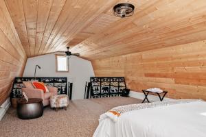 a bedroom with a bed and a wooden ceiling at Hygge Up North Bungalow in Bellaire