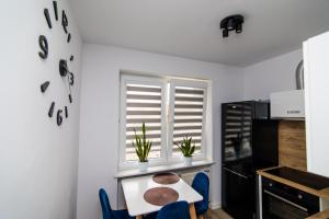 a kitchen with a table and chairs and a window at Apartament w Centrum in Iława
