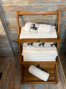 uma pilha de toalhas num suporte de madeira em Studio Mirage@Snow Residence (ski & forest) em Azuga