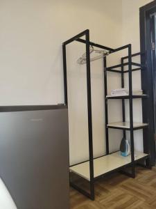 a black shelving unit in a room at Cozy Self-contained Serviced Apartment in Abuja