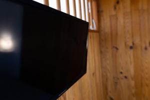 a flat screen tv sitting on top of a wooden wall at Studio sous les étoiles au coeur de Jaurès in Belfort