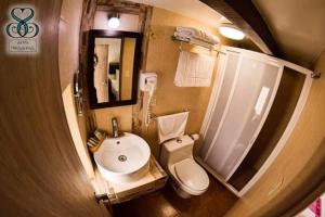 a bathroom with a sink and a toilet and a shower at Hotel Tres Sofias in Querétaro