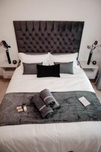 a bedroom with a large bed with a large headboard at Nelspruit 66 At Riverside Estate in Boschrand