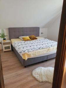 a bedroom with a bed and a rug at Olivér Apartmanház in Balatonlelle