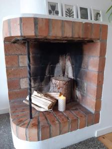 a brick fireplace with a candle in it at Bograngen LGH D in Brograngen