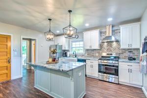 a kitchen with white cabinets and a counter top at Beautifully Restored Farmhouse in Marshall! in Marshall