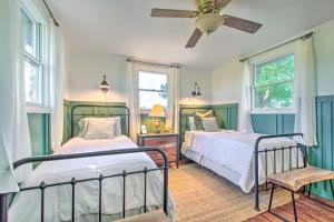 um quarto com 2 camas e uma ventoinha de tecto em Beautifully Restored Farmhouse in Marshall! em Marshall