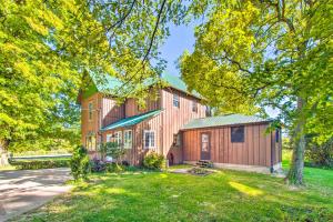 a large wooden barn with a green roof at Beautifully Restored Farmhouse in Marshall! in Marshall