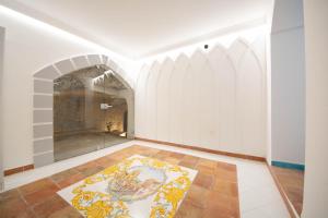 an empty room with a rug on the floor at Amalfi Ammorè in Amalfi