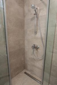 a bathroom with a shower with a glass door at LINA - PG, Moraca River Apartment in Podgorica