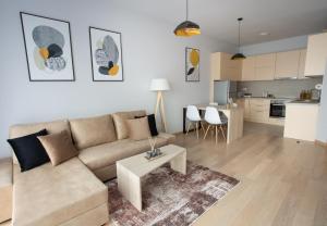 a living room with a couch and a table at LINA - PG, Moraca River Apartment in Podgorica