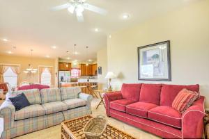 ein Wohnzimmer mit zwei roten Sofas und eine Küche in der Unterkunft Gulf Shores Family Home with Deck, Walk to Beach! in Gulf Shores